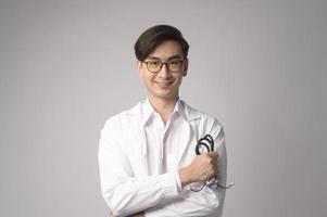 Portrait of male confident doctor over white background studio, healthcare and Medical technology concept. photo