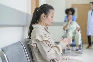 People waiting to visit doctor in front of reception in the hospital photo