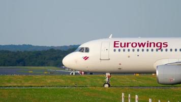 DUSSELDORF, GERMANY JULY 21, 2017 - Eurowings Airbus 320 D AEWW taxiing to the start at sunset. Dusseldorf airport video