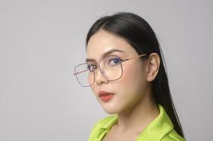 Portrait of Beautiful woman wearing glasses over white background studio, eyecare concept. photo