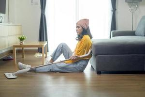 Young exhausted and tired housekeeper wearing yellow shirt in living room. photo