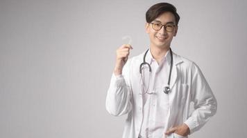 Portrait of male confident doctor over white background studio, healthcare and Medical technology concept. photo