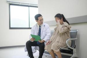 Asian Doctor is working in hospital , talking with sadness woman , medical health care concept photo