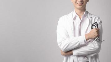 Portrait of male confident doctor over white background studio, healthcare and Medical technology concept. photo