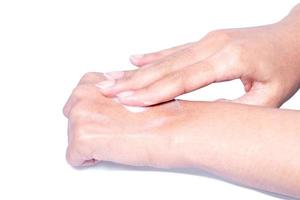 Closeup woman applying protective cream on hands. photo