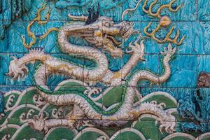 White dragon with green crest on the wall photo