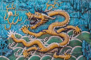 Flying yellow imperial dragon on the wall photo