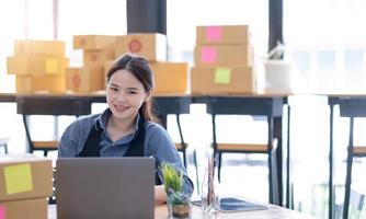 Portrait of Starting small businesses SME owners, Asian woman check online orders Selling products online and working with boxs freelance work at home Asian sme business online small medium enterprise photo