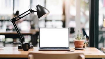 Workspace blank screen Computer and equipment on table and blurred background photo