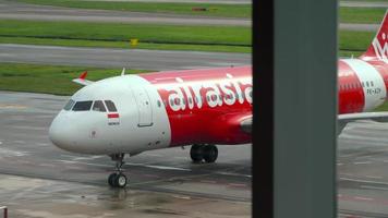 CHANGI, SINGAPORE NOVEMBER 25, 2018 - Lowcost Airbus A320, PK AZH of AirAsia taxiing to the terminal after landing at Changi airport, Singapore. Indonesian AirAsia plane arriving video