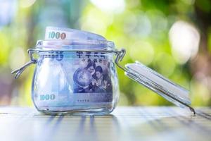 Taiwan banknotes in glass jar. photo