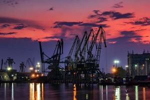 the silhouette of port cranes, at stunning twilight photo