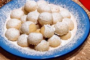 Homemade cookies with powdered sugar on a plate. Close up. photo