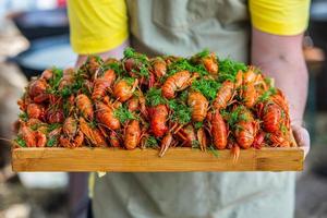 Boiled red crayfish or crawfish with herbs. Crayfish boiling in the pot on the fire photo