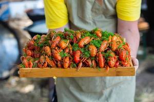 Boiled red crayfish or crawfish with herbs. Crayfish boiling in the pot on the fire photo