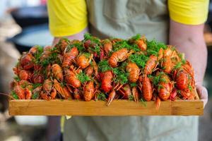 Boiled red crayfish or crawfish with herbs. Crayfish boiling in the pot on the fire photo