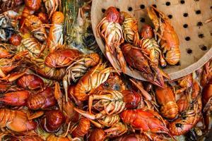 Boiled red crayfish or crawfish with herbs. Crayfish boiling in the pot on the fire photo