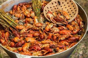 Boiled red crayfish or crawfish with herbs. Crayfish boiling in the pot on the fire photo