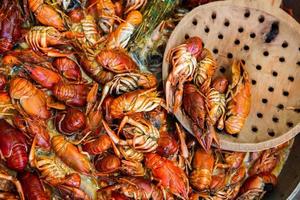 Boiled red crayfish or crawfish with herbs. Crayfish boiling in the pot on the fire photo