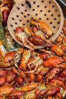 Boiled red crayfish or crawfish with herbs. Crayfish boiling in the pot on the fire photo