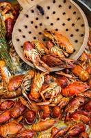 Boiled red crayfish or crawfish with herbs. Crayfish boiling in the pot on the fire photo