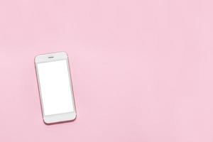 White smartphone mobile phone with white screen on pink background with copy space photo