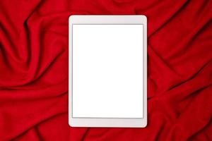 Black mock up electronic tablet on red fabric background. Mobile app mockup. Smartphone blank screen, phone mockup. photo