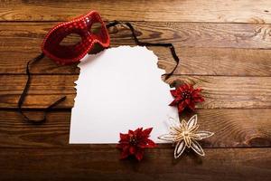 Christmas card and New Year accessories on brown wooden table. Top view. Copy space and place for text. photo
