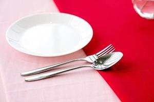 Dinner plate, fork and spoon photo