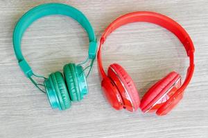 Red and green headphone on wood background. photo