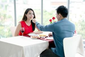 A pair of lovers, a man and a woman, eat french fries,Romantic date, family holiday, Valentine's Day. photo