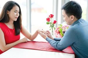 Man proposing engagement ringto his girlfriend photo