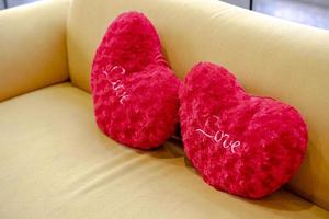 Heart shape pillow on sofa. Valentines day love. photo