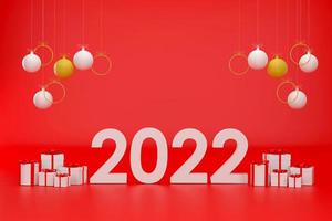 2022 White Christmas ball, gift box and golden ring at Christmas festival on a red background. photo