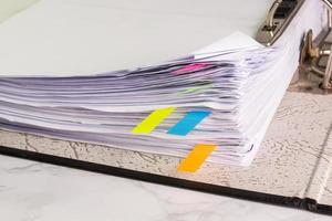 white paper stack in folder file for a business contract, income, expenses photo