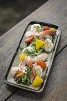 prawn and egg salad on rustic wood table photo