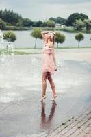 woman model posing in dress near fountain photo