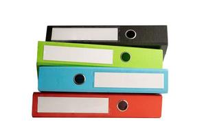 File Folder Binder stack of multi color on table in business office. photo