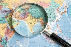 Bangkok, Thailand - May 01, 2022 Africa, Magnifying glass close up with colorful world map photo