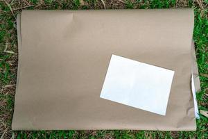 flipboard paper on the grass with a4 white paper size on the top, prepares for college student workshop. photo