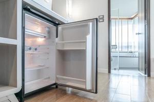 opened small refrigerator under the counter and in front of toilet in delux room at resort and hotel. photo