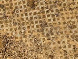 gray color stone brick block floor tile with green grass and sand as background or texture. photo