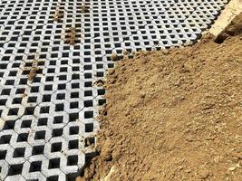 gray color stone brick block floor tile with green grass and sand as background or texture. photo