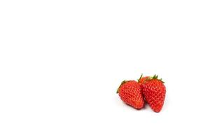 three isolated fresh strawberries on the pure white backgroud in studio light. Clipping path. photo
