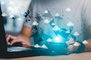 Hand using laptop with touch connect to data information on the Cloud Computing Technology Internet Storage Network Concept, big data internet technology, Cloud sharing download and upload. photo