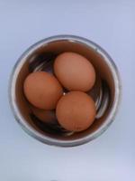 Three chicken eggs in a bowl photo