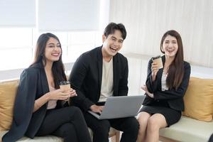 Young coworkers. Young modern colleagues in smart casual wear working while spending time in the office. Business man at the office with a laptop. photo