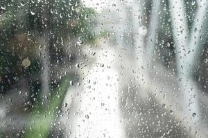 ciudad de la mañana, vista a través de la ventana en un día lluvioso. gotas de agua en el vaso en un día lluvioso. gotas de lluvia durante la lluvia en un día lluvioso fuera del cristal de la ventana con fondo borroso. foto