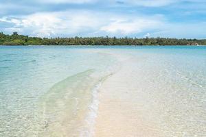 the beach that split in the middle of the ocean. A natural separated sea phenomenon photo