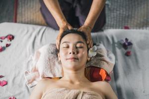 Massage and spa relaxing treatment of office syndrome traditional thai massage style. Asain female masseuse doing massage treat back pain, arm pain and stress for office woman tired from work. photo